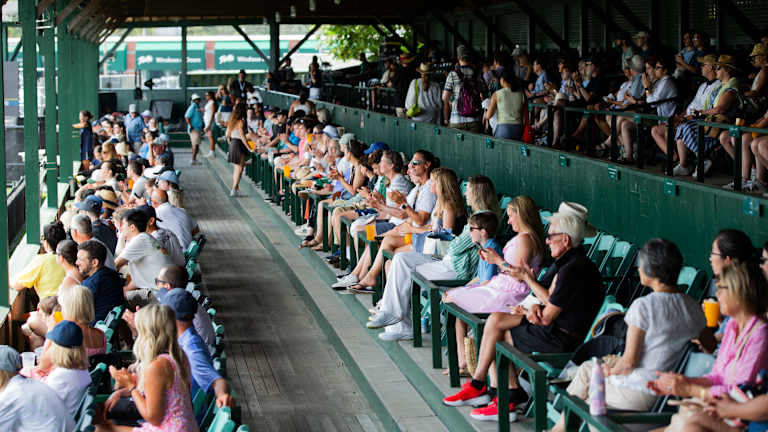 Fans are seated on a veranda that's stood for generations.